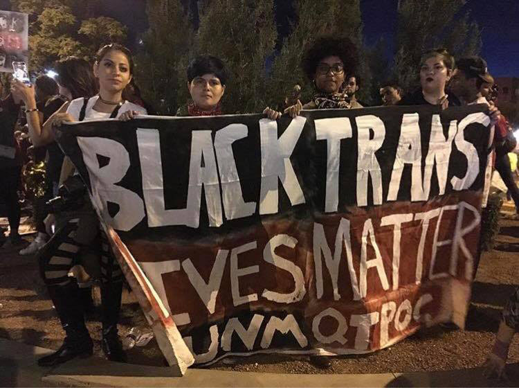 Students holding a banner displaying the text Black Trans Lives Matter