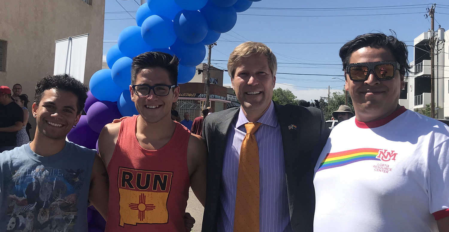 Mayor Keller posing outside with members of the LGBTQRC