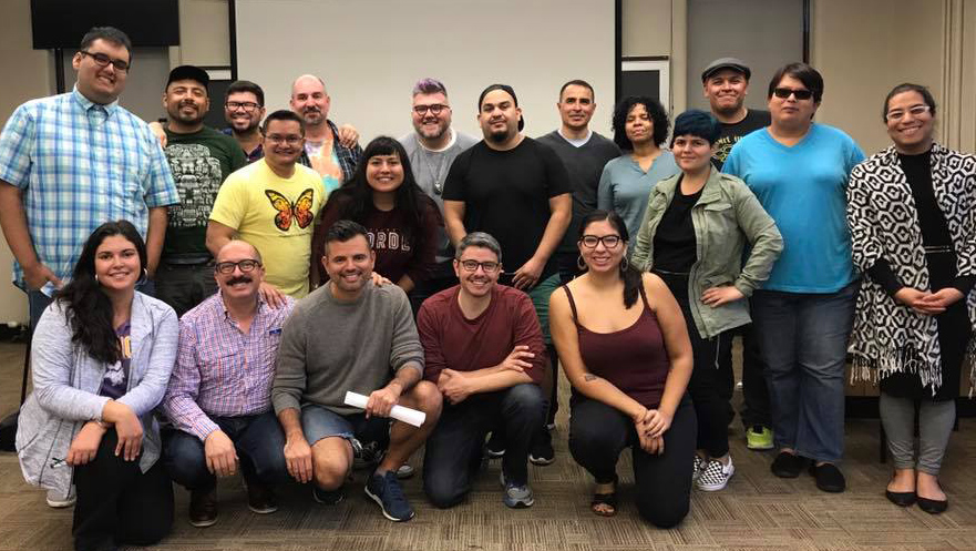 Photo of LGBTQRC members posing in a classroom